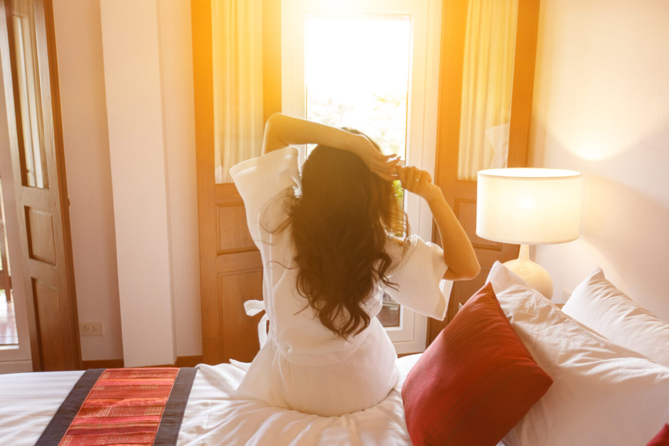 Woman just woke up in the morning and sitting on bed