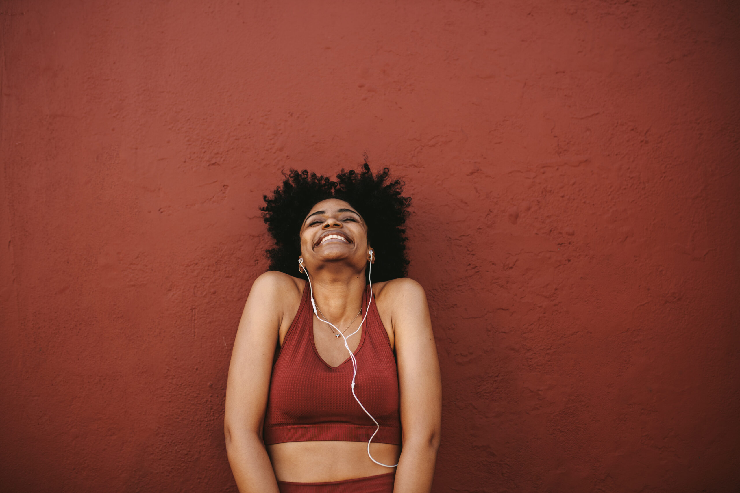 Fitness woman smiling listening to music